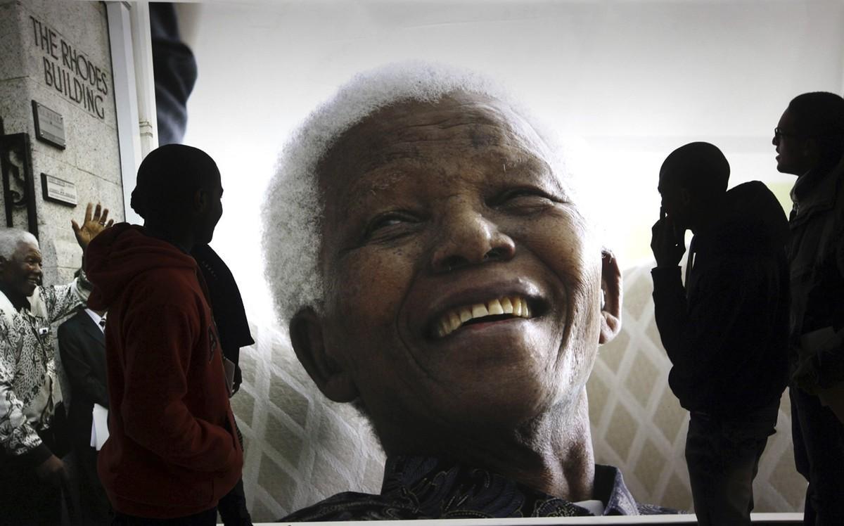 FILE - In this June 27  2013 file photo  large photographs of former South African President Nelson Mandela are displayed at the Nelson Mandela Legacy Exhibition at the Civic Centre in Cape Town  South Africa  The United Nations is seeking to harness the soaring symbolism of Mandela  whose South African journey from anti-apartheid leader to prisoner to president to global statesman is one of the 20th century s great stories of struggle  sacrifice and reconciliation  The unveiling of a statue of Mandela  born 100 years ago  with arms outstretched at the U N  building in New York on Monday  Sept  24  2018  opens a peace summit at the General Assembly   AP Photo  File