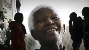 FILE - In this June 27  2013 file photo  large photographs of former South African President Nelson Mandela are displayed at the Nelson Mandela Legacy Exhibition at the Civic Centre in Cape Town  South Africa  The United Nations is seeking to harness the soaring symbolism of Mandela  whose South African journey from anti-apartheid leader to prisoner to president to global statesman is one of the 20th century s great stories of struggle  sacrifice and reconciliation  The unveiling of a statue of Mandela  born 100 years ago  with arms outstretched at the U N  building in New York on Monday  Sept  24  2018  opens a peace summit at the General Assembly   AP Photo  File