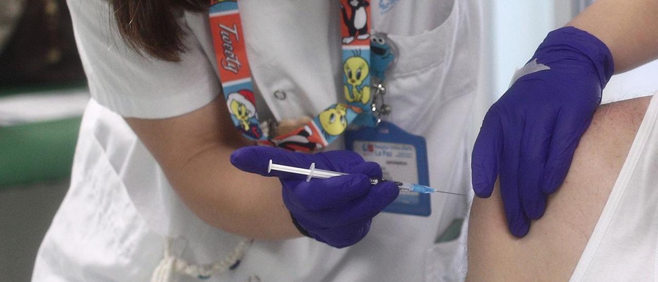 Una sanitaria administra una dosis de la vacuna contra la Covid-19. | EP