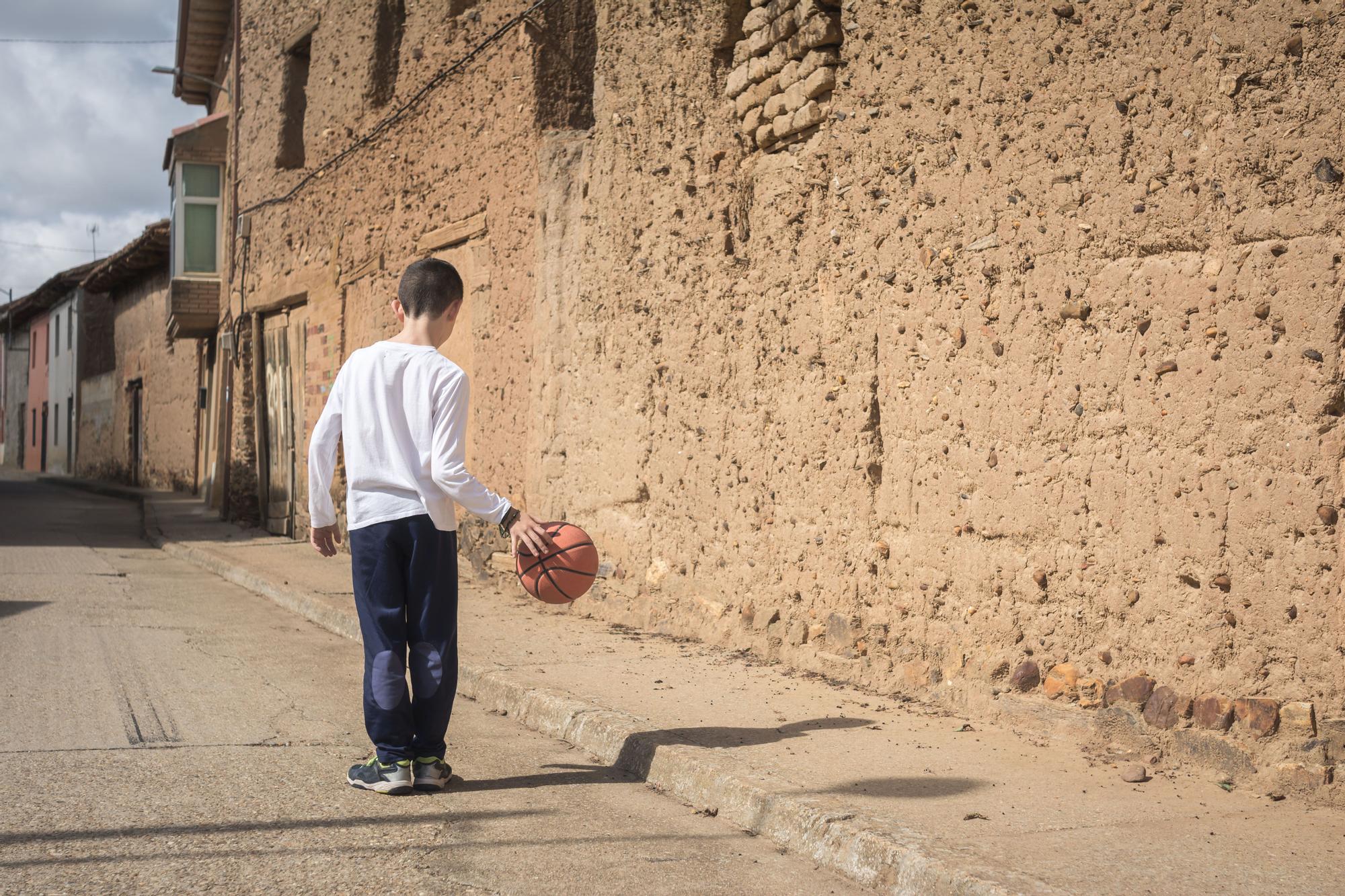 Un niño juega en las calles de un pueblo de la España vaciada.