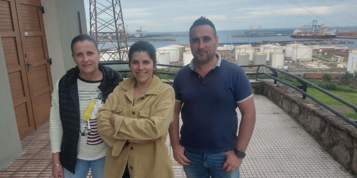 Por la izquierda, Rita Rendueles, Cristina García y Ana Sierra, con el puerto de El Musel a sus espaldas. | Ángel González