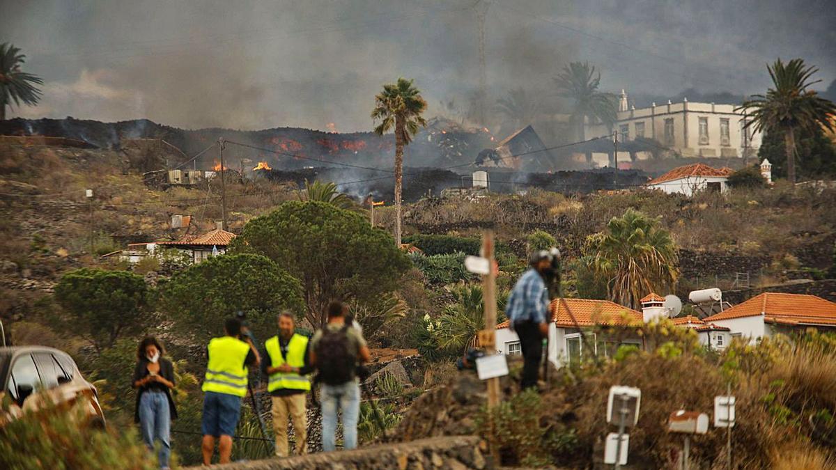 Varios medios de comunicación informan desde un lugar cercano al volcán en erupción.