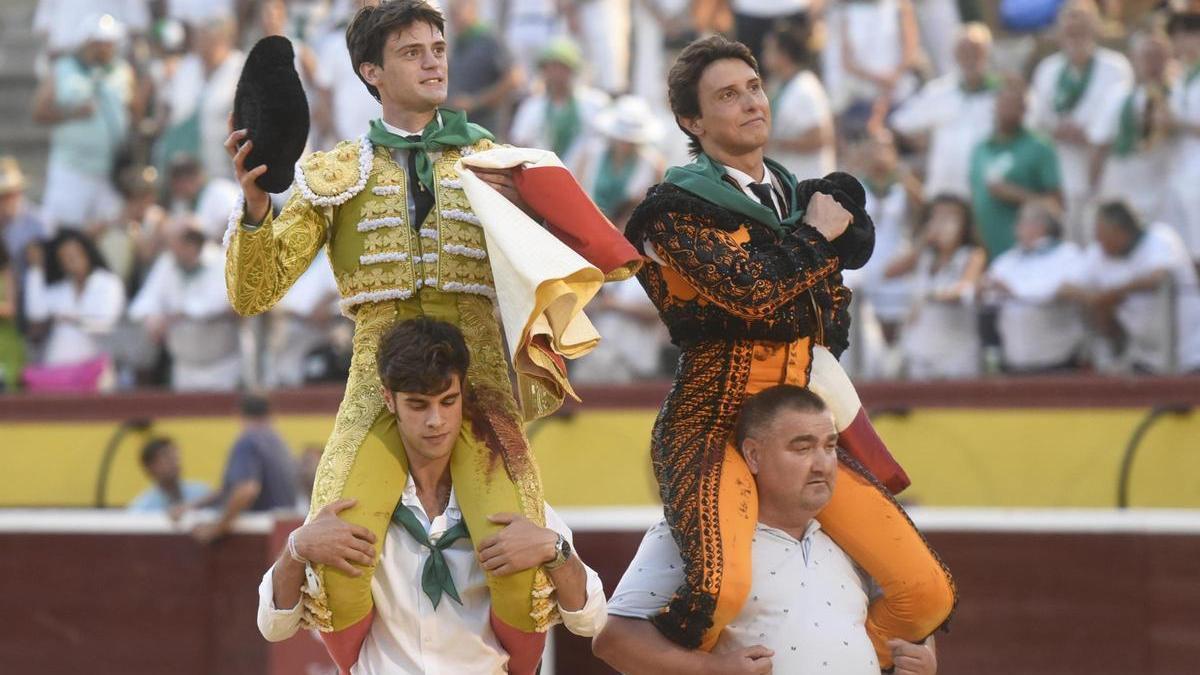 Los diestros Cristiano Torresy Roca Rey (d) salen por la puerta grande tras la corrida de la Feria Taurina celebrada este miércoles.