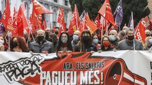 Un grupo de personas con una pancarta participa en una concentración para exigir la recuperación del poder adquisitivo de los salarios frente a la sede de la Confederación Empresarial de la Comunidad Valenciana, a 16 de diciembre de 2021 bajo el lema Ahora, los salarios, ¡Pagad más!.