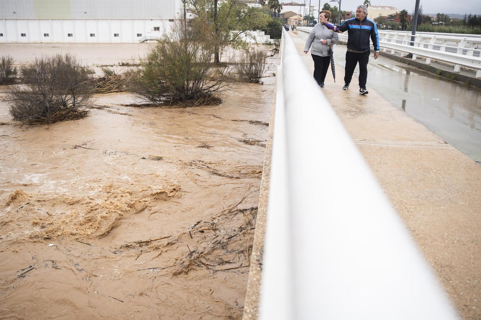Varias personas observan la crecida del río Magre, a 29 de octubre de 2024, en Alfarp, Valencia, Comunidad Valenciana (España). El Centro de Coordinación de Emergencias (CCE) ha elevado a rojo el nivel de alerta por lluvias en todo el litoral e interior norte de Valencia, donde estaba fijada la alerta naranja. De este modo, el CCE ha actualizado los planes de emergencia por la DANA que afecta este martes, 29 de octubre, a la Comunitat Valenciana, y que a primera hora de la mañana establecía el nivel rojo solo para el litoral sur de València. 29 OCTUBRE 2024;DANA;INUNDACIONES; Jorge Gil / Europa Press 29/10/2024. Jorge Gil;