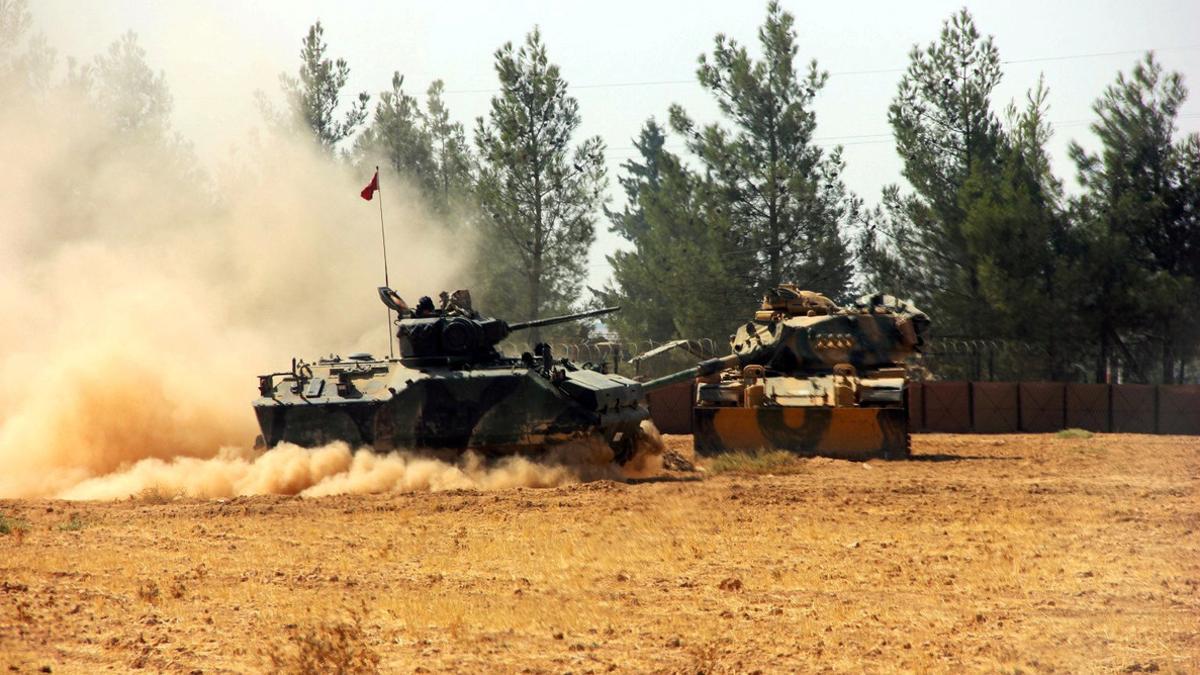 A Turkish army tank and an armoured vehicle are stationed near the Turkish-Syrian border in Karkamis in the southeastern Gaziantep province