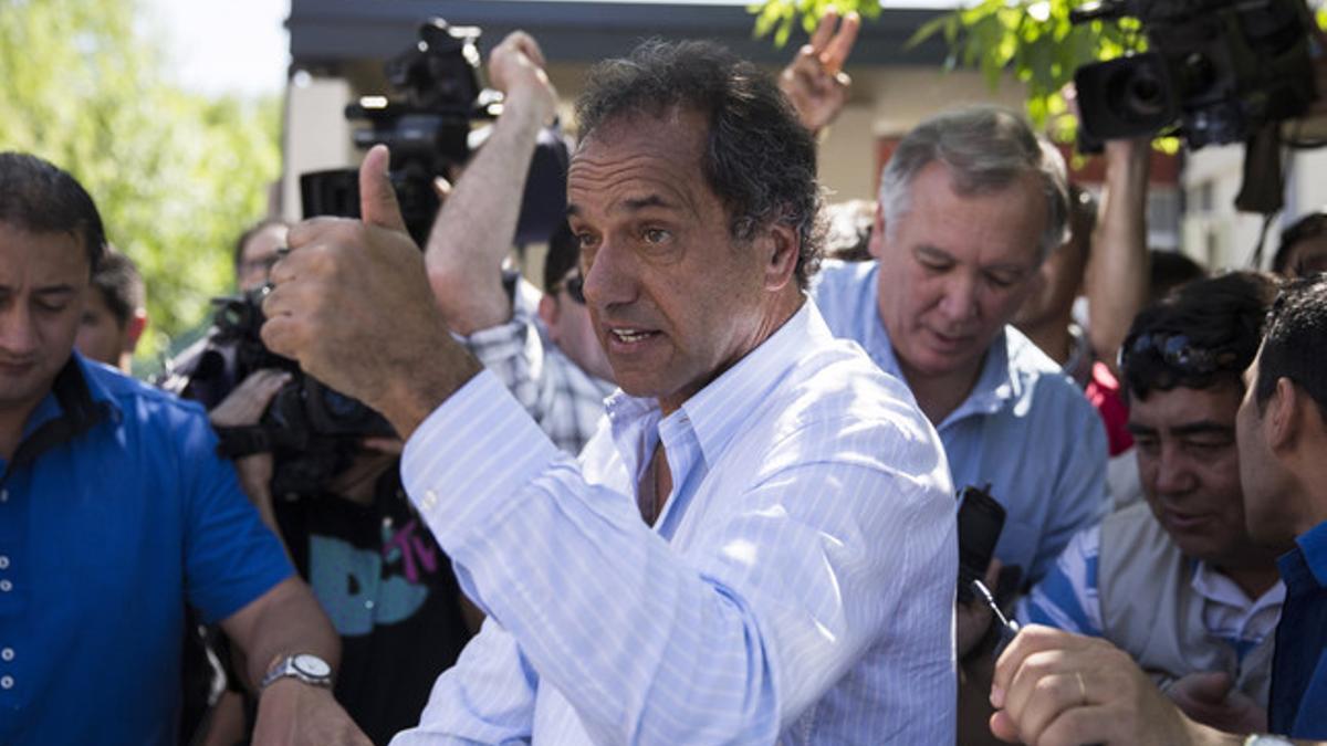 Daniel Scioli saluda tras votar en Tigre, este domingo.