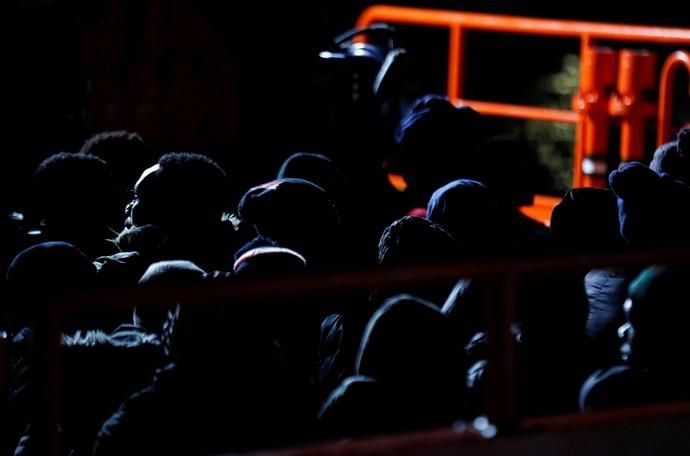 Migrants wait to disembark from a Spanish coast ...