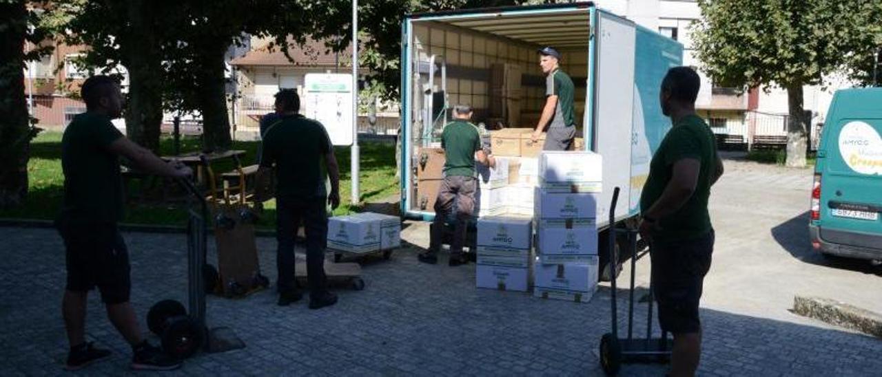 La empresa carga un camión con varias cajas de libros.