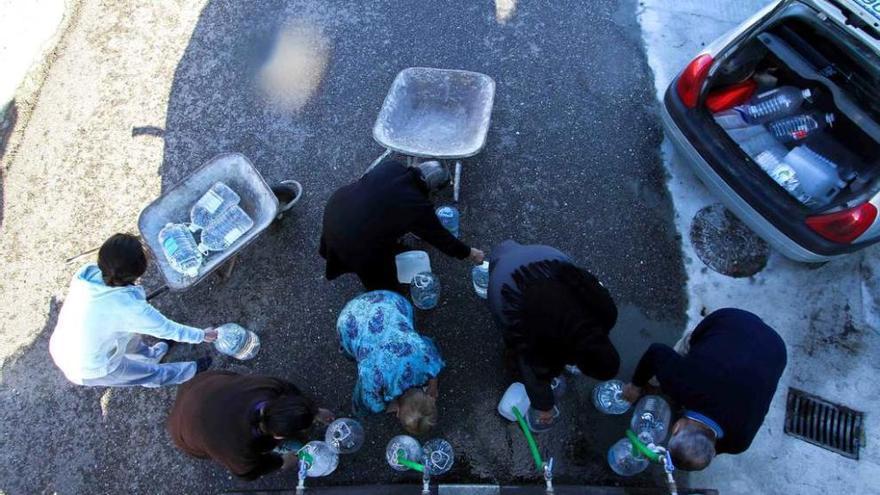 Vecinos de Castro de Alcañices se abastecen de agua en un camión cisterna.