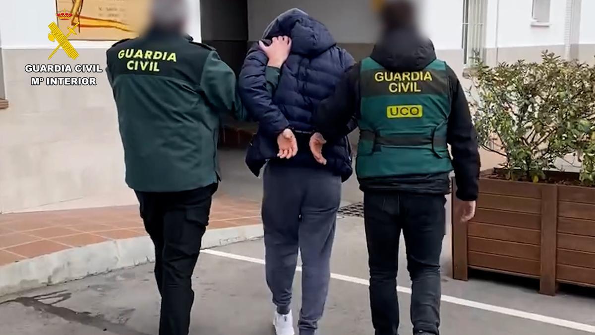 Dos agents de la Guàrdia Civil porten el fugitiu de Romania fins a la caserna policial.