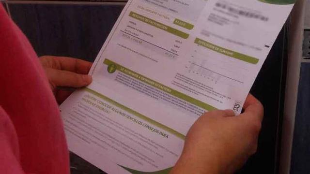 Una mujer consulta la factura de la luz.