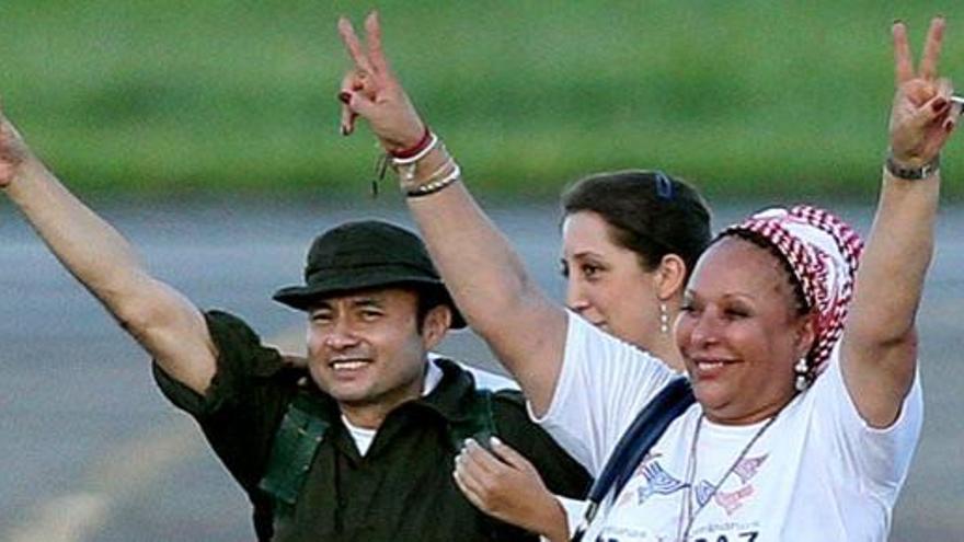 El sargento de la Policía César Augusto Lasso Monzalve (i), junto a la exsenadora Piedad Córdoba (d), saluda a su llegada al aeropuerto.