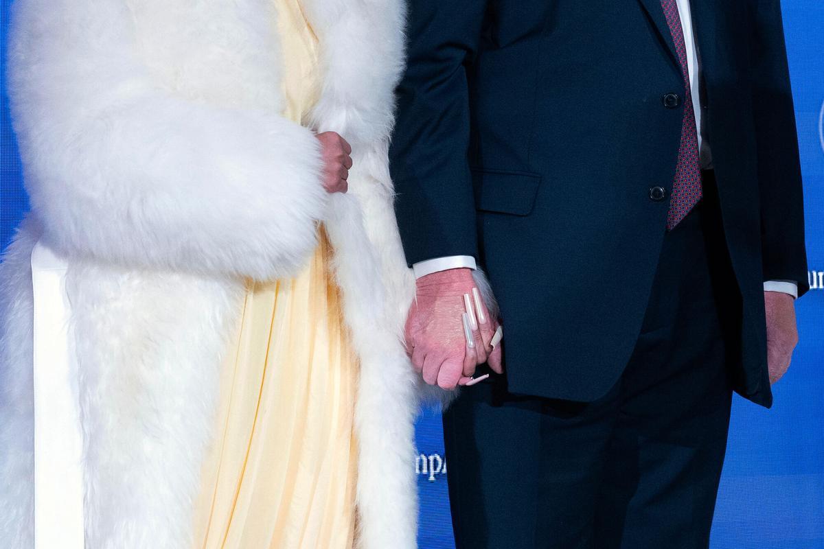 Nicki Minaj and President Donald Trump hold hands during the launch of a program known as Trump Accounts at Carnegie Mellon Auditorium, Wednesday, Jan. 28, 2026, in Washington. (AP Photo/Jose Luis Magana). EDITORIAL USE ONLY/ONLY ITALY AND SPAIN