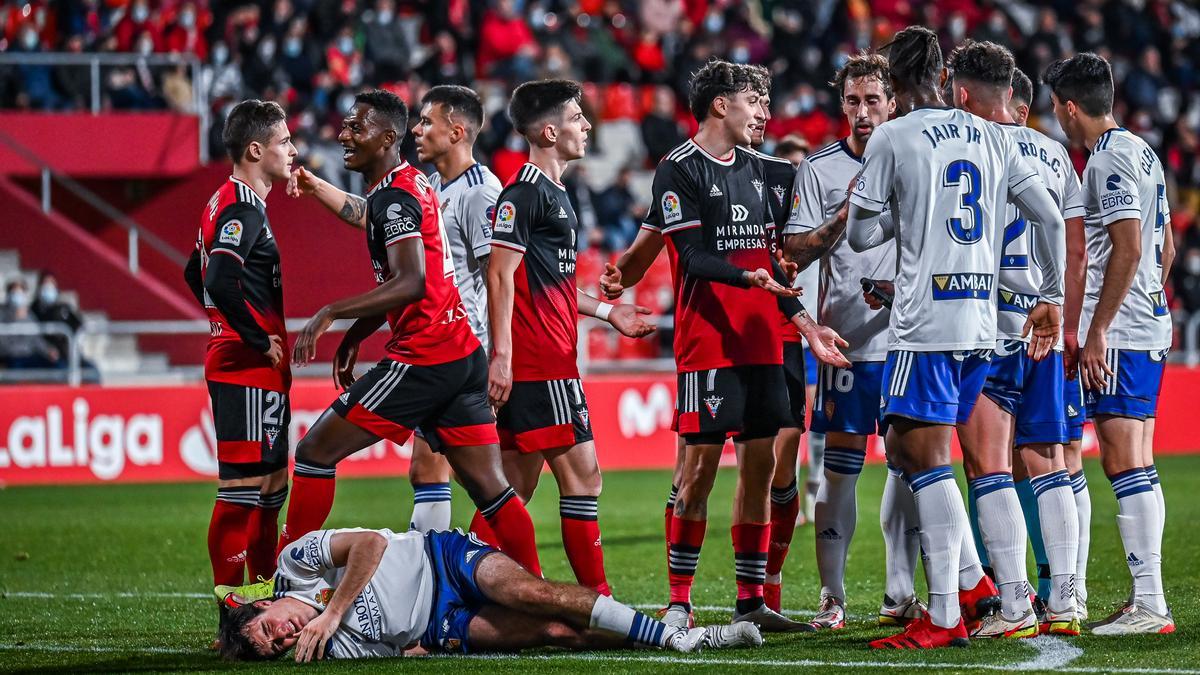 Los jugadores del Zaragoza hablan con los del Mirandés mientras Francho se duele en el último partido liguero.