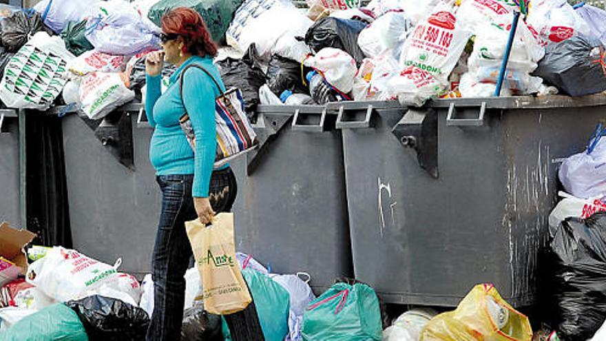 Estampa que ofrecían, a media mañana de ayer, varios contenedores atestados de basura, poco antes de iniciarse la retirada de restos.