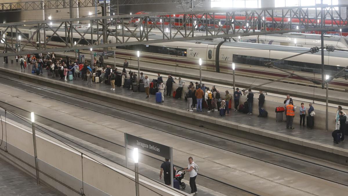 Decenas de pasajeros esperan en la Estación Delicias la llegada de su tren, este lunes por la tarde en plena incidencia.