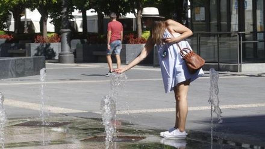 Una mujer juega con el agua en Las Tendillas.
