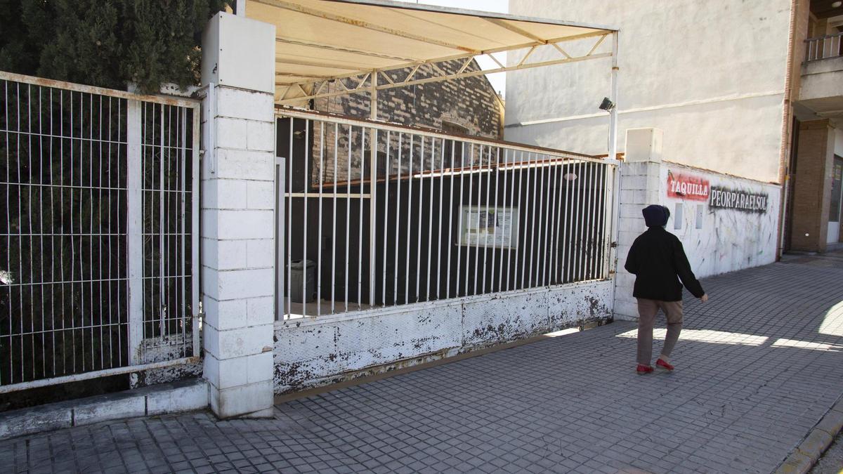 Una vecina pasa frente a la puerta de acceso la discoteca «Peor para el sol» en Ontinyent.