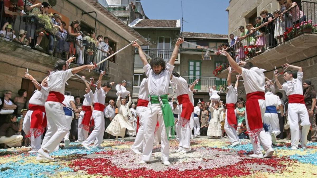 Danza das Espadas e das Penlas sobre alfombra floral na Festa da Coca de Redondela.   