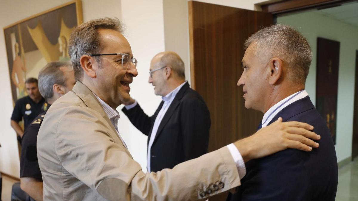 El director de operaciones del Sporting, Carlos Barcia, a la izquierda, saluda a Jesús Álvarez, jefe de seguridad del Oviedo, ayer, en la sede de la Delegación del Gobierno. | Luisma Murias