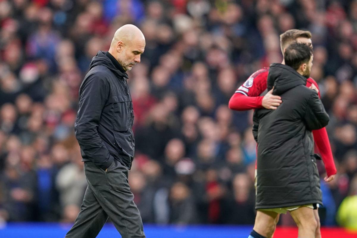 Manchester City's head coach Pep Guardiola walks on the pitch after the English Premier League soccer match between Manchester United and Manchester City in Manchester, England, Saturday, Jan. 17, 2026. (AP Photo/Dave Thompson)
