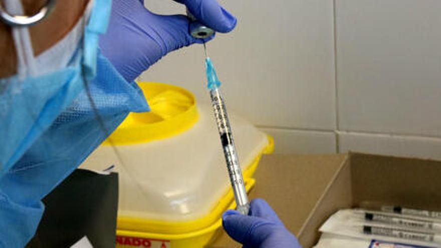 Pla escorç d&#039;una infermera preparant una injecció de la vacuna contra la covid-19.