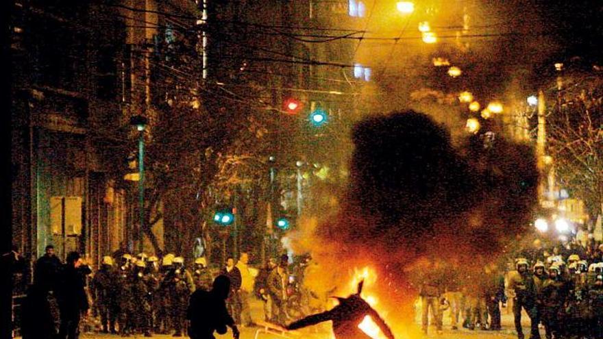 Estudiantes griegos protestan ante policías antidisturbios durante una manifestación en Atenas.