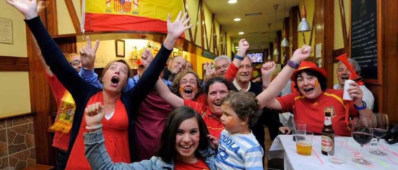 Aficionados celebrando una victoria de España en un bar de Oviedo.