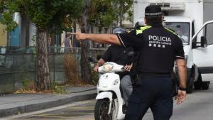 Un agente de la Guardia Urbana controla el tráfico en Barcelona