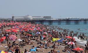 La gente se agolpa en la playa de Brighton mientras los británicos experimentan el día más caluroso registrado en el Reino Unido con temperaturas previstas de 40 grados.