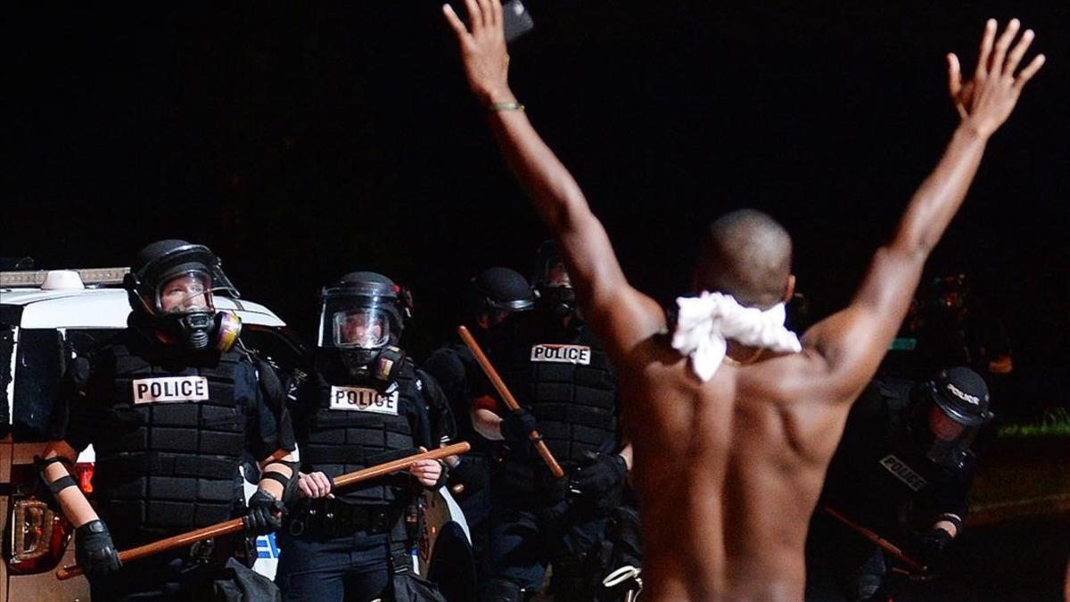 jjubierre35622431 a protester raises his arms in front of officers in charlott160921165700