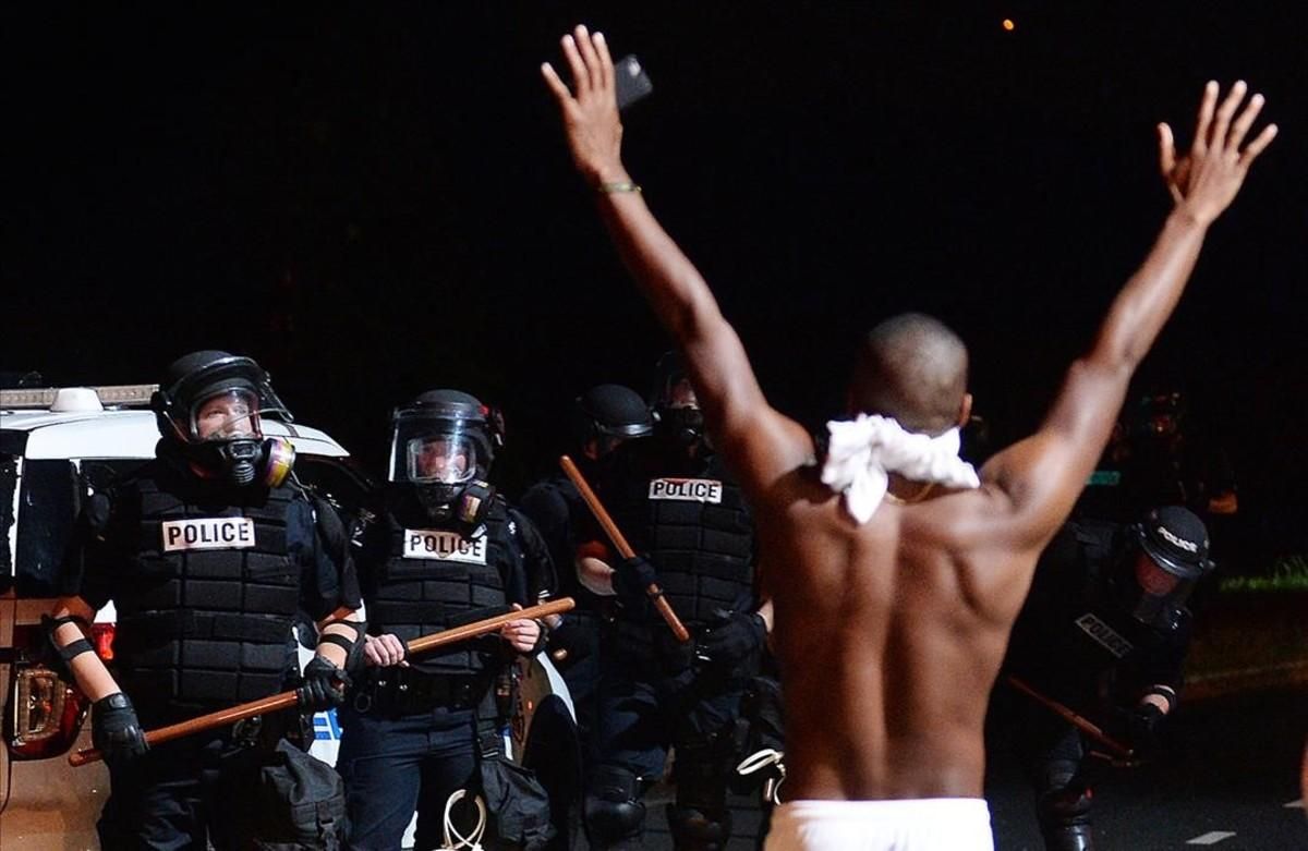 jjubierre35622431 a protester raises his arms in front of officers in charlott160921165700