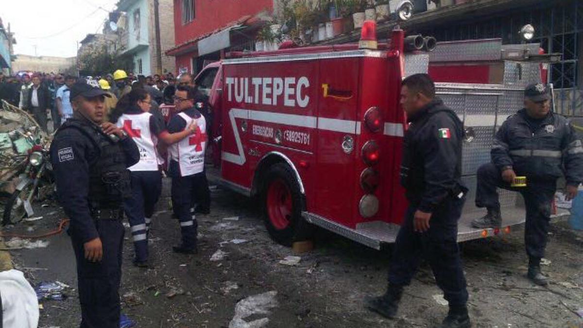 Bomberos y policías en el lugar de la explosión.