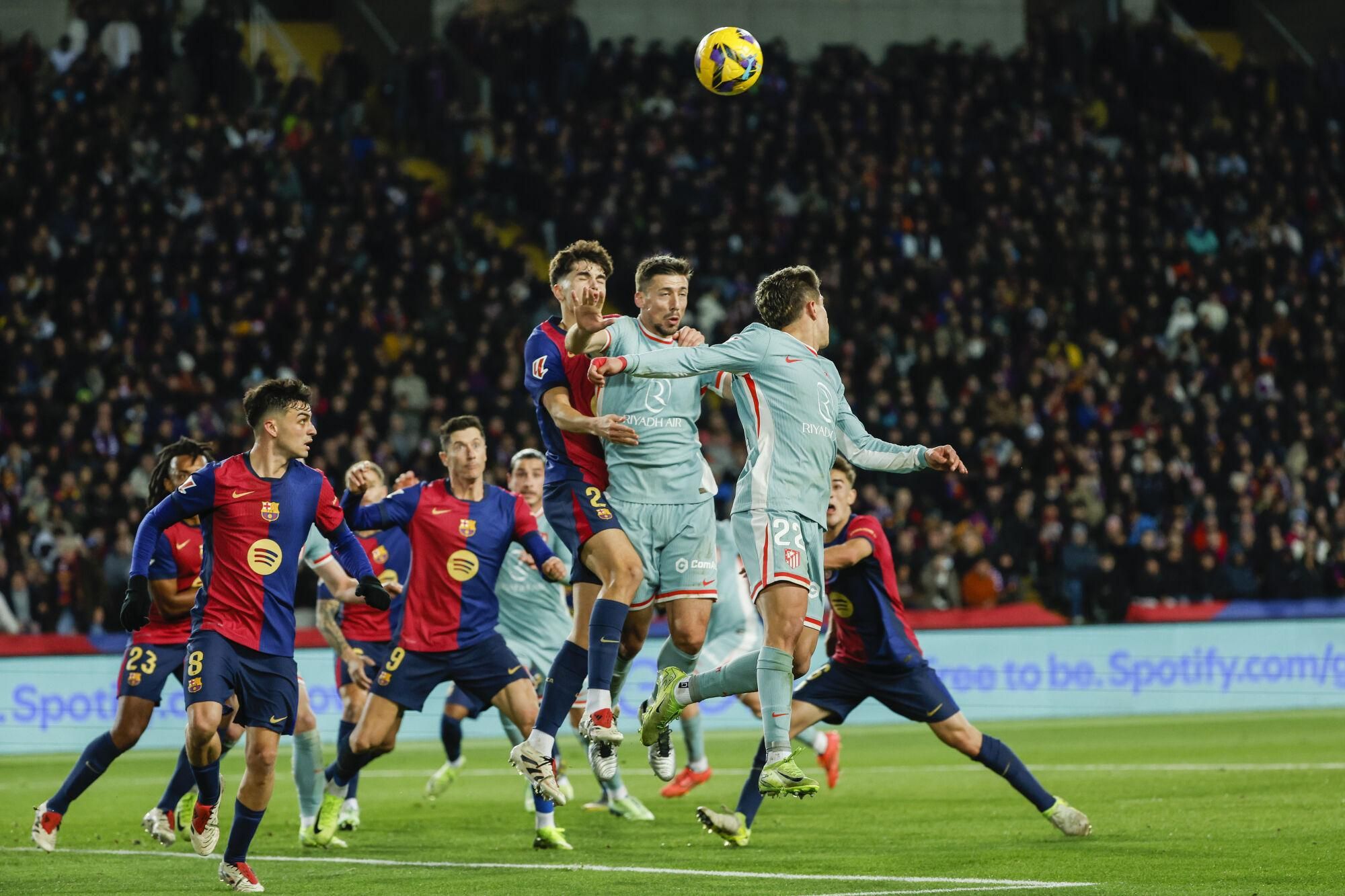 Barcelona and Atletico Madrid players compete during their Spanish La Liga soccer match at the Lluis Companys Olympic Stadium in Barcelona, Spain, Saturday, Dec. 21, 2024. (AP Photo/Joan Monfort)