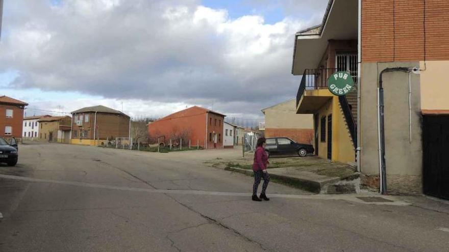 Una vecina pasa por una calle de Santa María de la Vega.