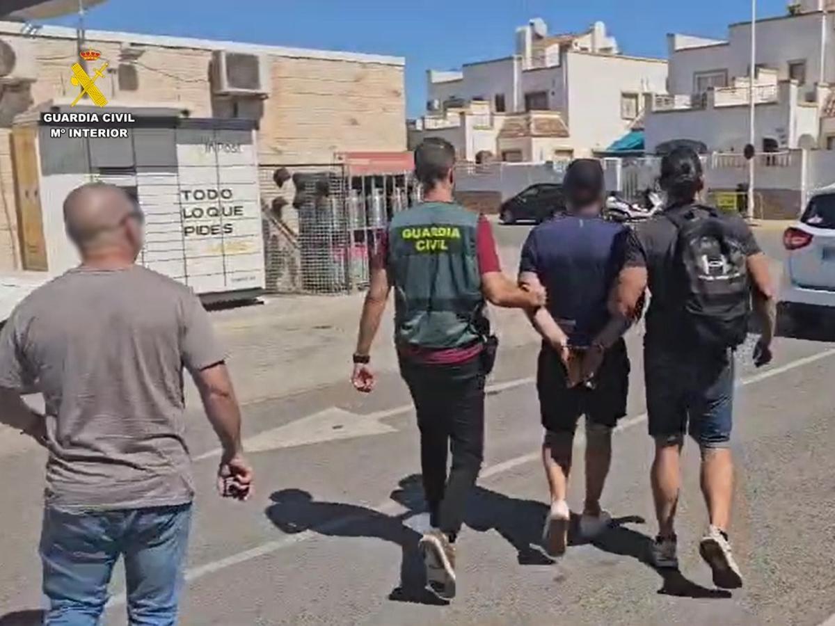 Traslado del detenido en el aparcamiento del supermercado de Torrevieja