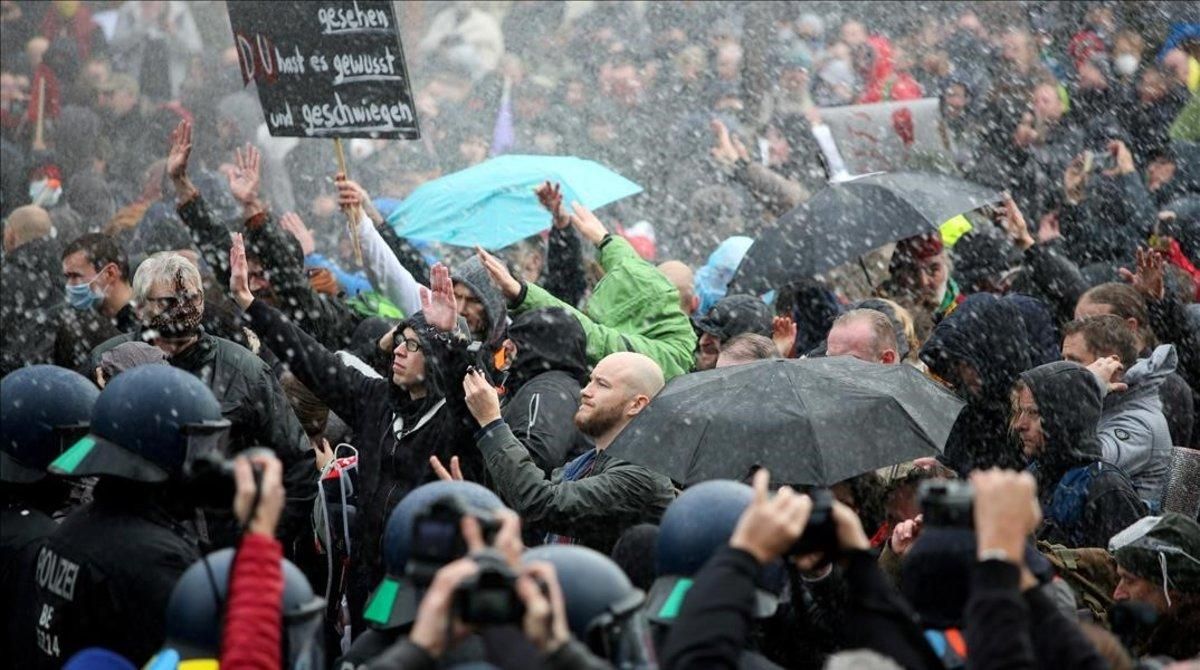 undefined55913802 demonstrators are sprayed with a water cannon during a prote201118190913