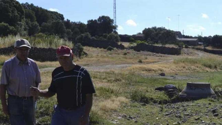 Dos vecinos de Badilla caminan por los ámbitos de la ribera del pueblo, recorrida por un viejo y roto saneamiento.