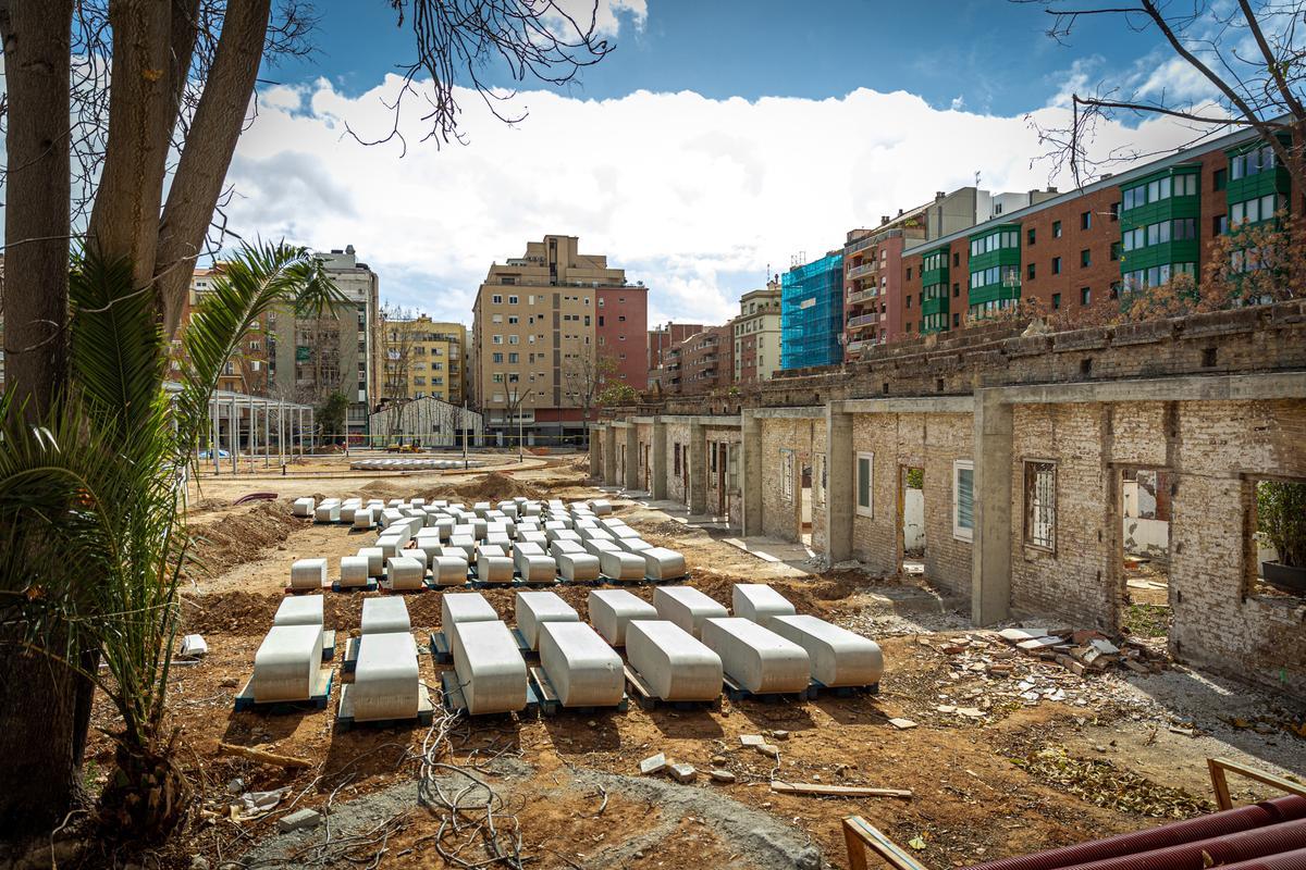 Bancos pendientes de instalar en el terreno de la antigua Colònia Castells, en Barcelona, donde se construye un parque.