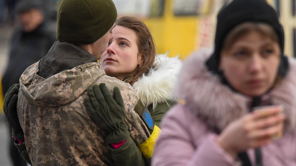 09 March 2022, Ukraine, Lviv: Olga says goodbye to her boyfriend Volodimir as soldiers heading east to the front lines in the war with Russia at a train station in Lviv.