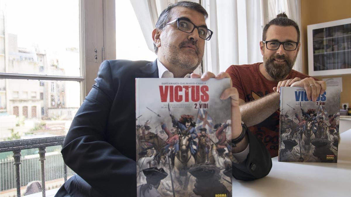 El guionista Carles Santamaria y el dibujante Cesc F. Dalmases, con las ediciones castellana y catalana de 'Victus 2. Vidi', en la sede de Norma Editorial.