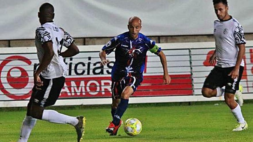 Sergio García, autor del gol de la victoria, conduce el balón ante dos rivales del Salamanca UDS.