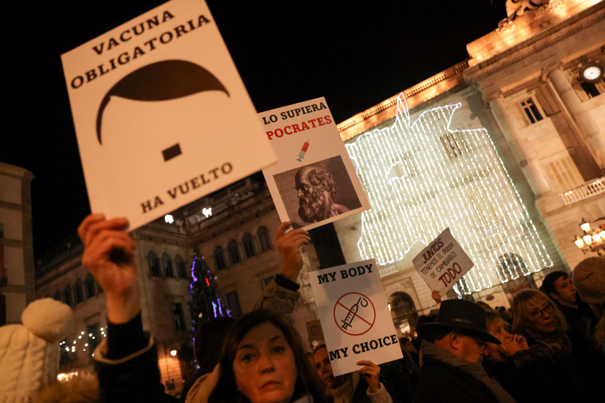 Una mujer levanta un cartel contra la vacunación obligatoria durante la manifestación