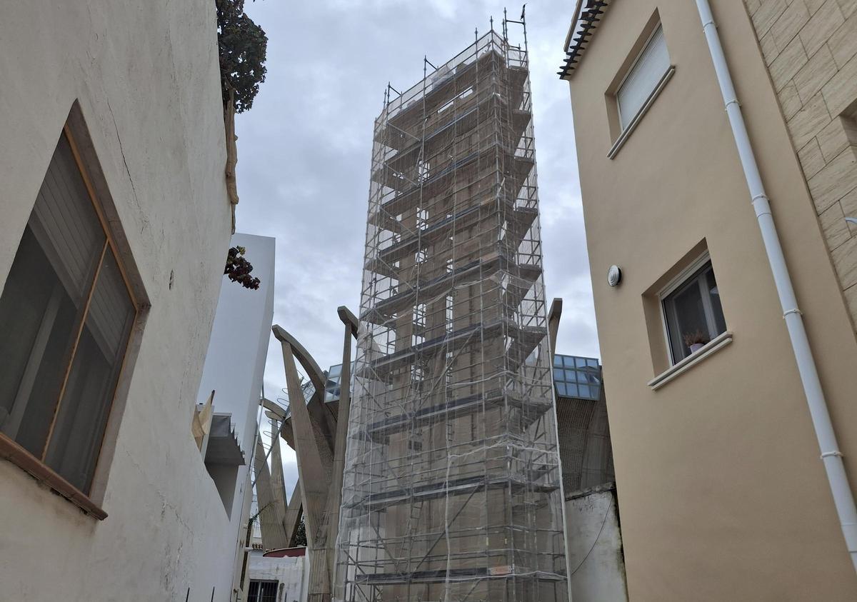 Imagen de la torre triangular envuelta con el andamio