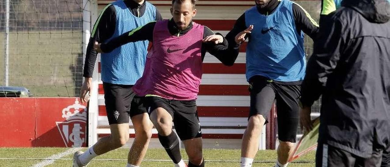 Aitor García conduce el balón junto a Molinero, en presencia de Cristian Salvador.