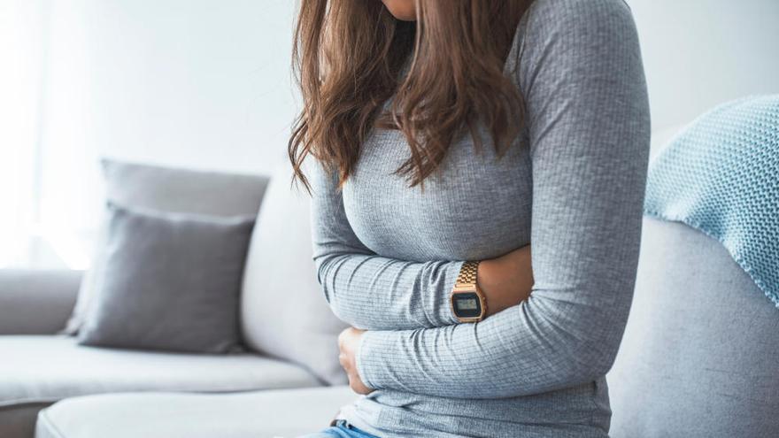 Una mujer con dolor de estómago.