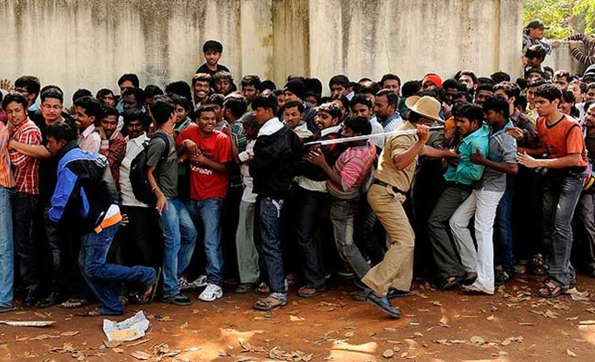 A Bangalore, un policia tracta de posar en ordre les persones que formen la cua per aconseguir entrades per al partit del Mundial de criquet, en el qual s’enfrontaran l’Índia i Anglaterra.