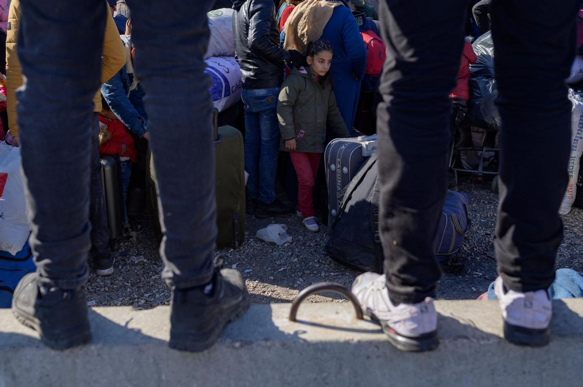 Los residentes sirios de la ciudad de Hatay esperan para cruzar la frontera entre Turquía y Siria después de que se vieron afectados por el terremoto de magnitud 7,8 que asoló la región hace casi dos semanas, en la puerta fronteriza de Cilvegozu