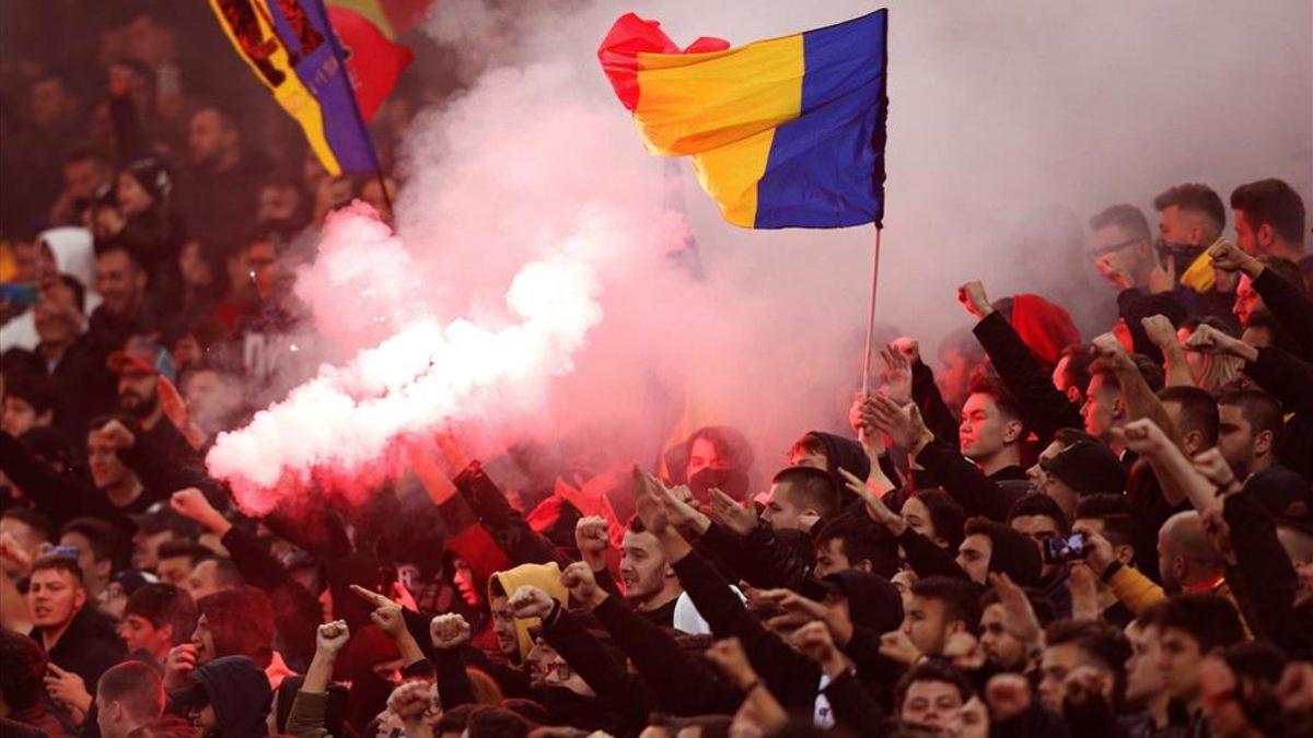 Los aficionados rumanos con bengalas en el partido